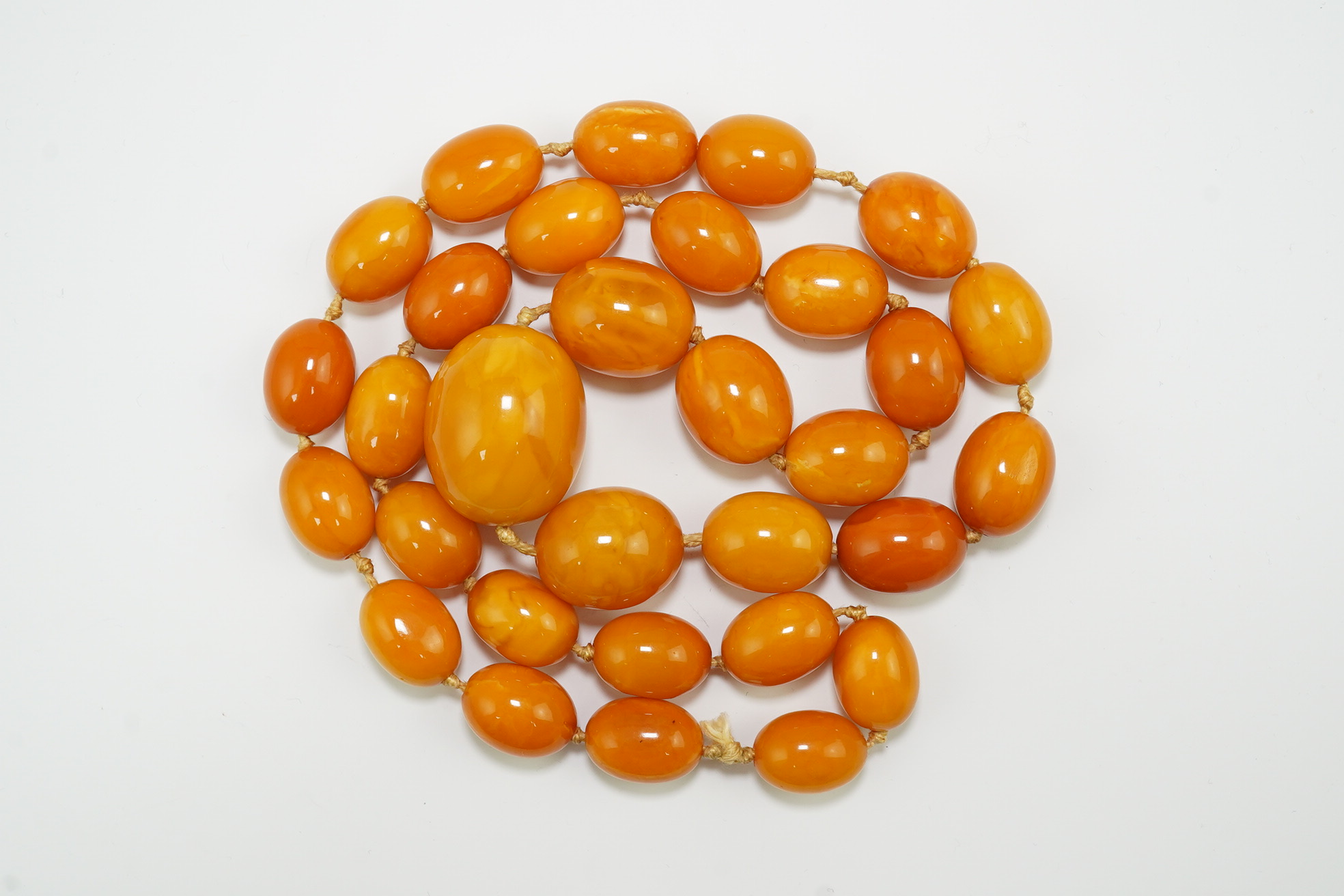 A single strand graduated oval amber bead necklace